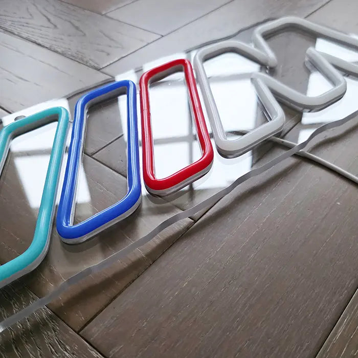 M Stripes neon LED sign, evenly lit neon line across the full width of the design