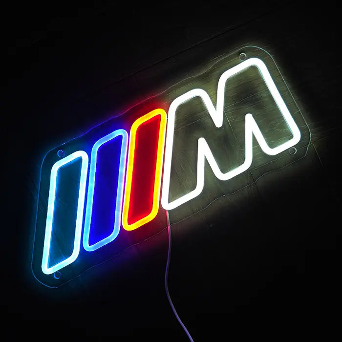 M Stripes neon LED sign, standing on a smooth surface with the light reflecting below