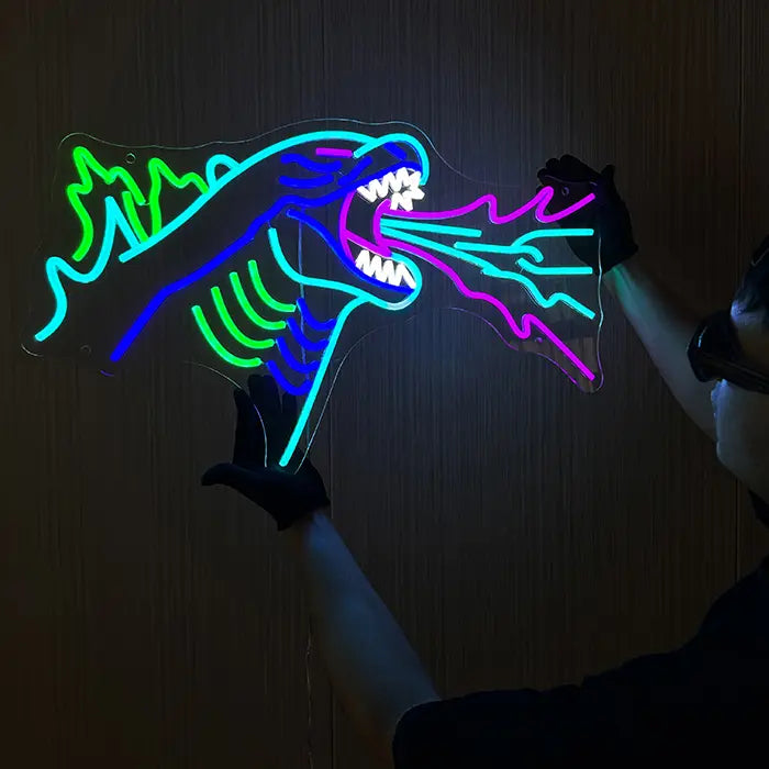 Godzilla Neon LED Sign held against the wall with gloves and aligned