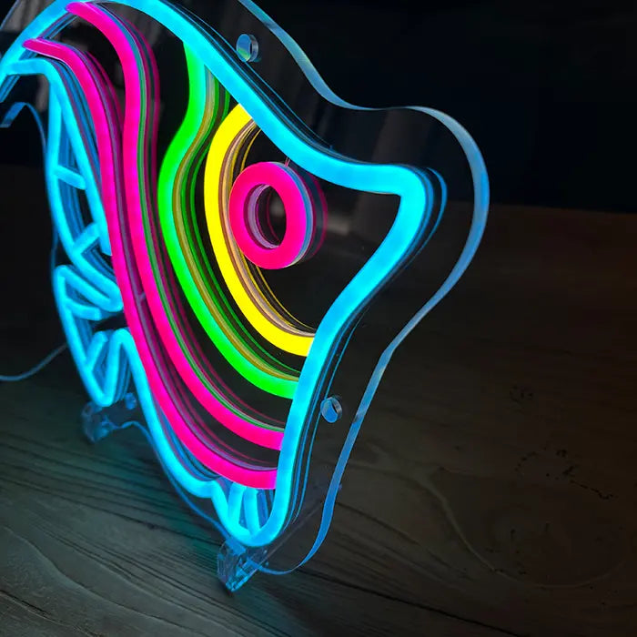 Ocean Fish Neon LED Sign at an angle on a wooden surface, clear acrylic panel with stands visible