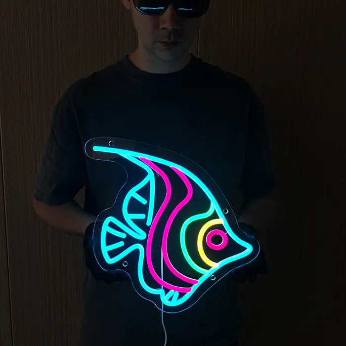 Ocean Fish Neon LED Sign held in front of the body, the complete fish contour glowing