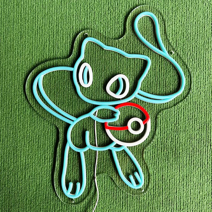 Pokémon Mew Neon LED Sign switched off on a green surface, the complete outline visible