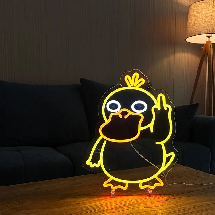 Pokémon Psyduck Middle Finger Neon LED Sign standing on a wooden table with a sofa and floor lamp behind