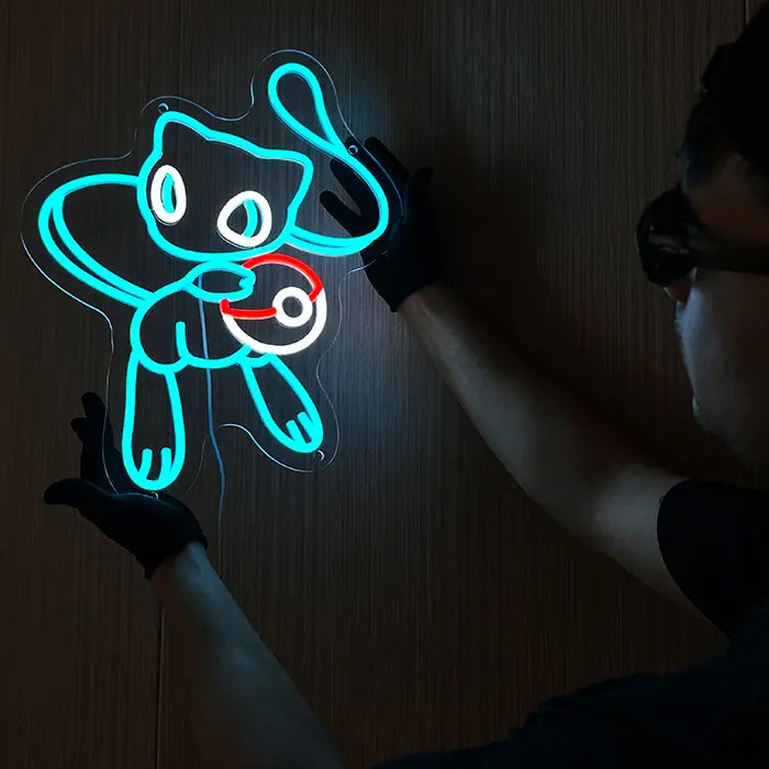 Pokémon Mew Neon LED Sign in blue being held against the wall with gloves and aligned