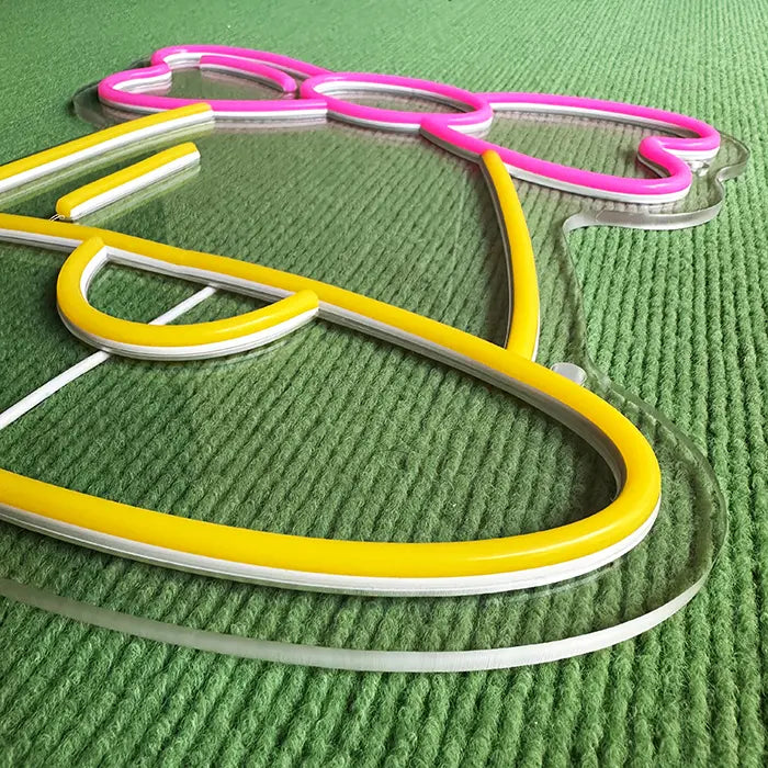 Little Bell Neon LED Sign switched off at an angle from above, the neon tubing standing proud of the acrylic