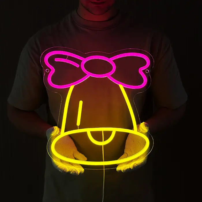 Little Bell Neon LED Sign held in front of the body with gloves, bell and bow glowing