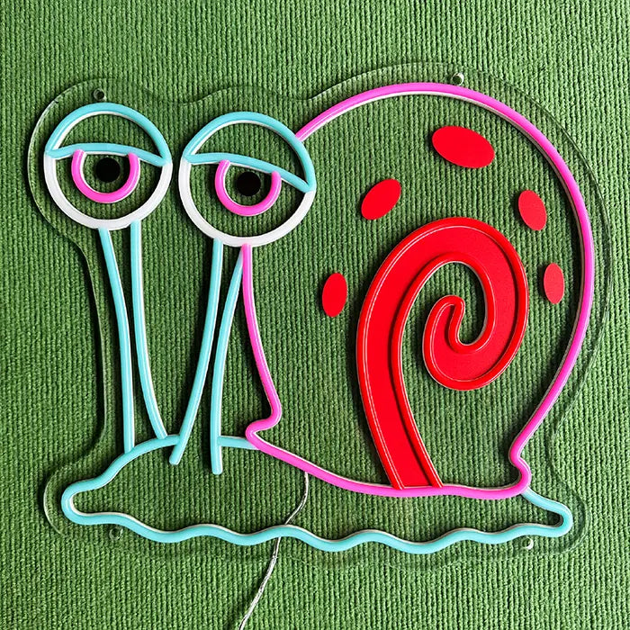 Gary the Snail Neon LED Sign switched off on a green surface, the complete contour visible