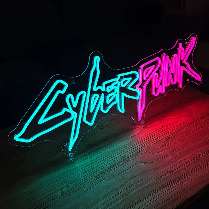 CYBERPUNK Neon LED Sign at an angle on a wooden surface, clear acrylic panel with stands visible