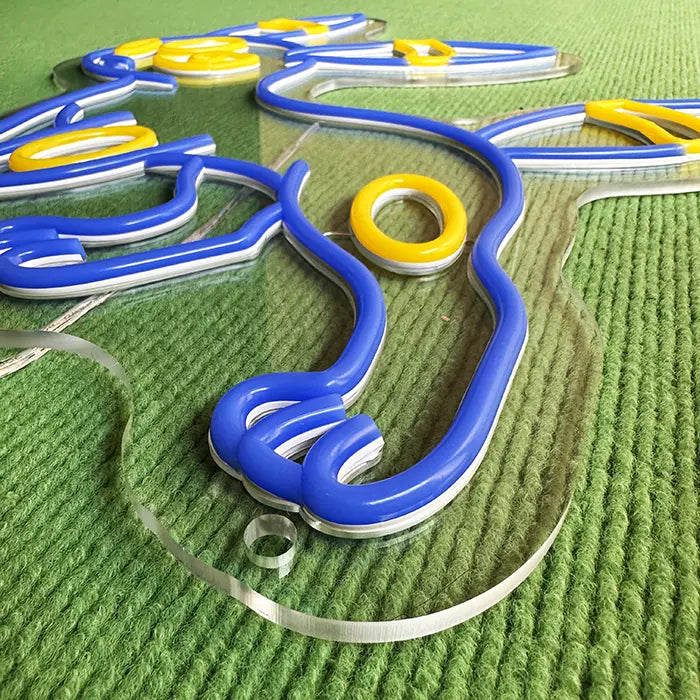 Pokémon Umbreon Neon LED Sign switched off at an angle on a green surface, neon tubing on acrylic