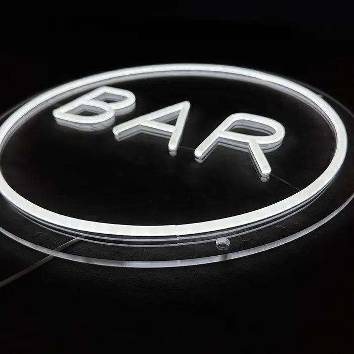 BAR Neon LED Sign at an angle from above against a black background, neon tubing standing proud of the clear acrylic