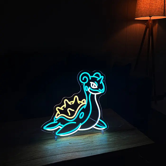 Pokémon Lapras Neon LED Sign on a wooden table in a dark room, next to it a floor lamp