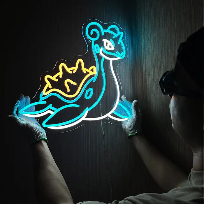 Pokémon Lapras Neon LED Sign being lined up on the wall, a person in gloves holds it in place