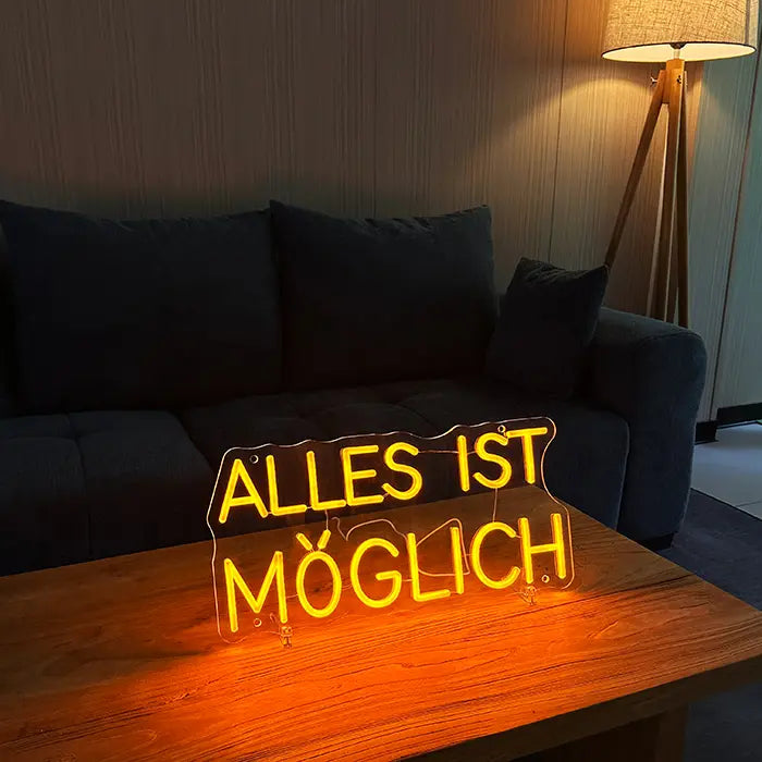 Anything Is Possible Neon LED Sign on a wooden table in front of a sofa, next to it a floor lamp