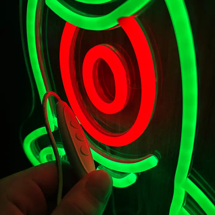 The Plankton Neon LED Sign in close-up with the inline dimmer in hand in front of the red eye