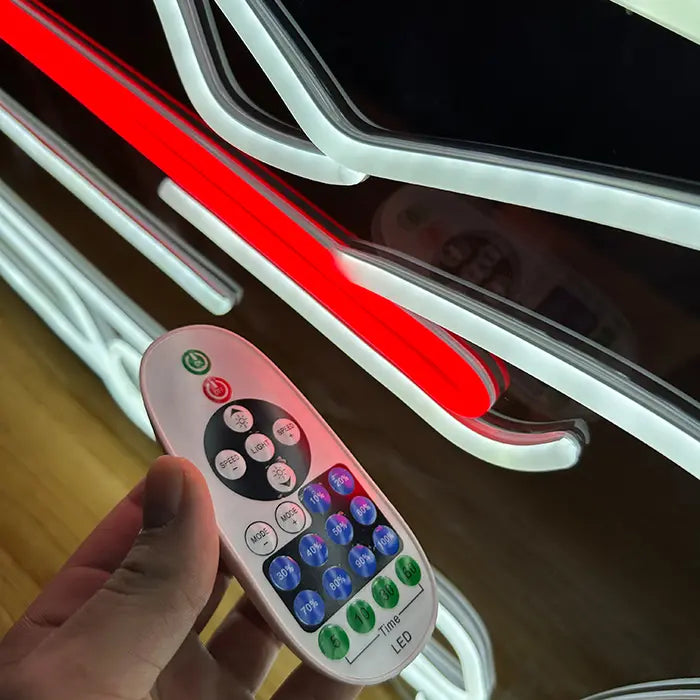 GT Sports Car Neon LED Sign in close-up with the remote control in hand in front of the light bar