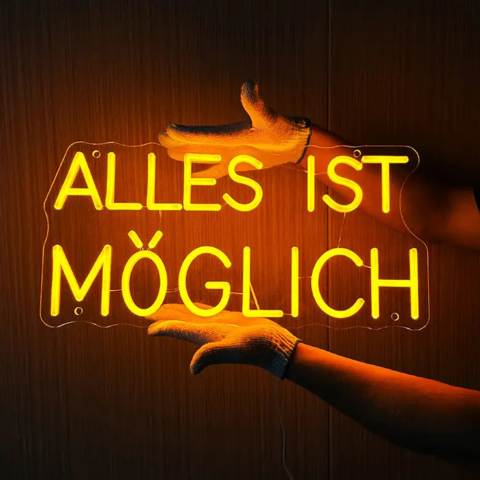 Anything Is Possible Neon LED Sign being held against a wooden wall with gloves