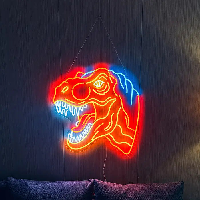T-Rex Dino Neon LED Sign hung on chains above a sofa, blue back crest glowing