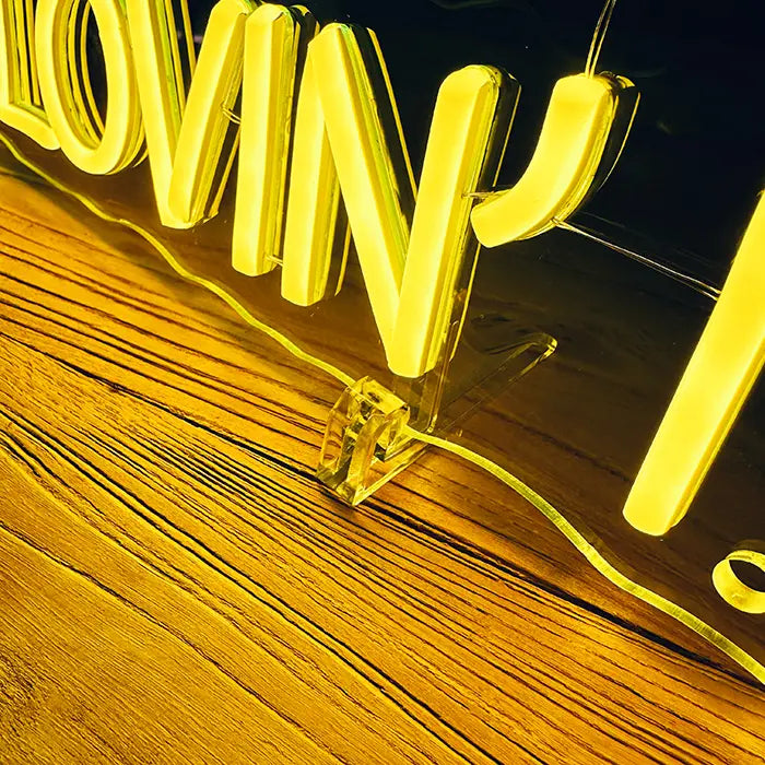 McDonald's Not Lovin' It Neon LED Sign in detail with a stand on a wooden surface, letters glowing