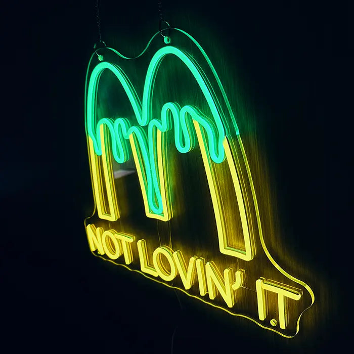 McDonald's Not Lovin' It Neon LED Sign hung on chains, glowing yellow and green against a dark wall