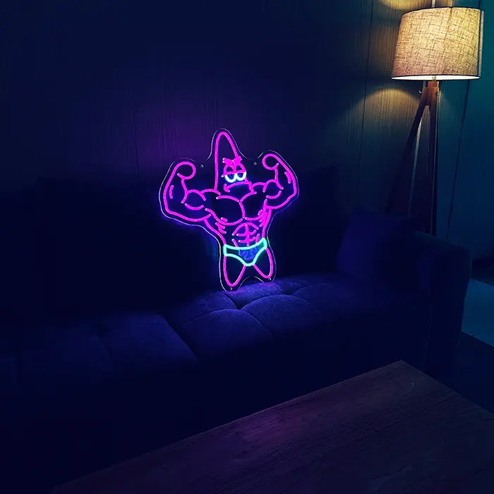 Patrick Bodybuilder Neon LED Sign set up on a dark sofa, next to it a floor lamp