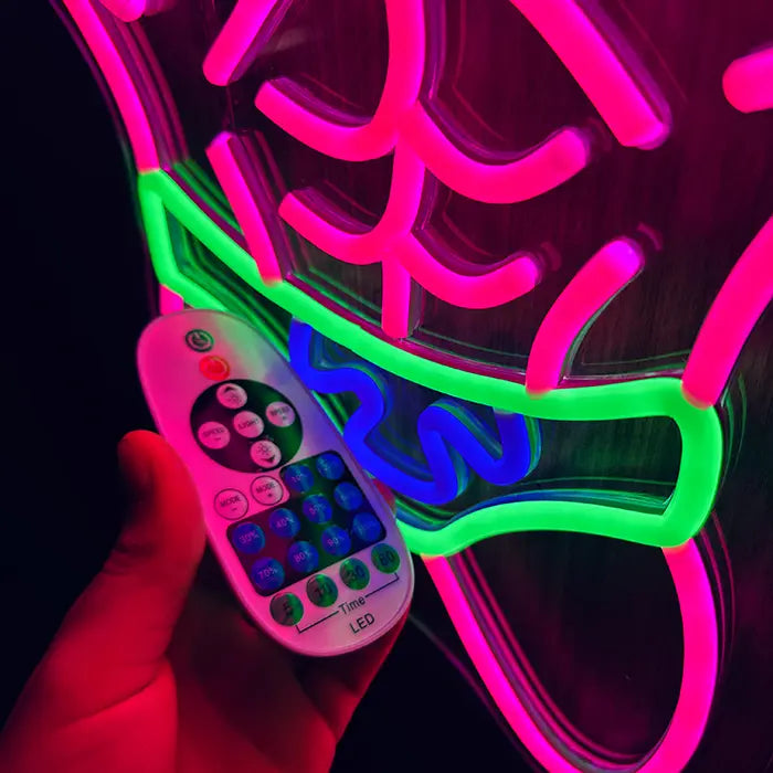 Patrick Bodybuilder Neon LED Sign in close-up with the remote control in hand in front of the swim shorts