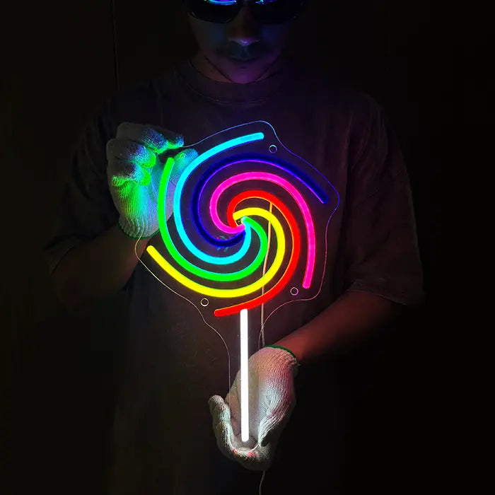 Lollipop Neon LED Sign held in front of the body with both hands, the colourful spiral glowing