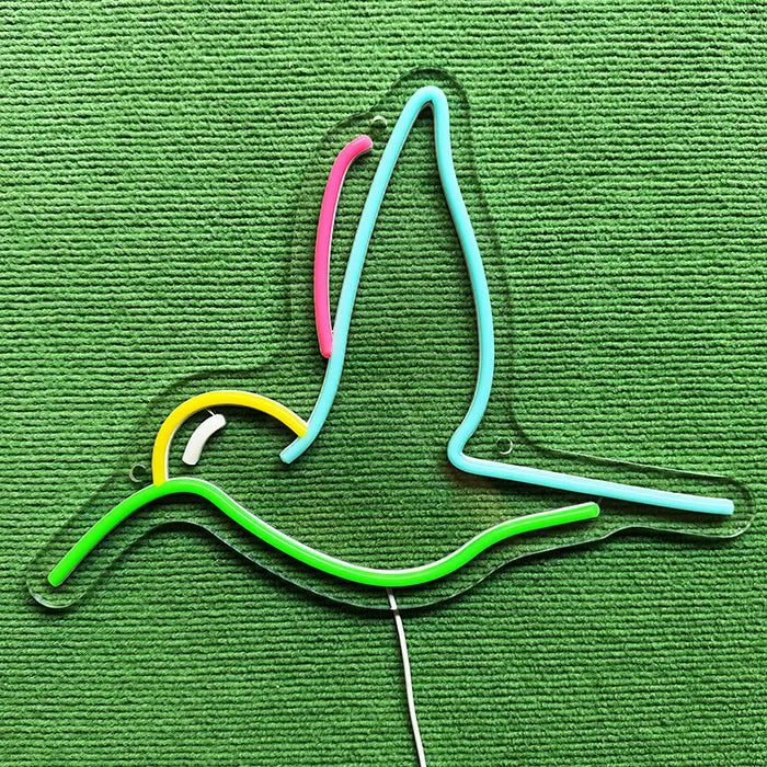 Hummingbird Bird Neon LED Sign switched off on a green surface, full outline visible