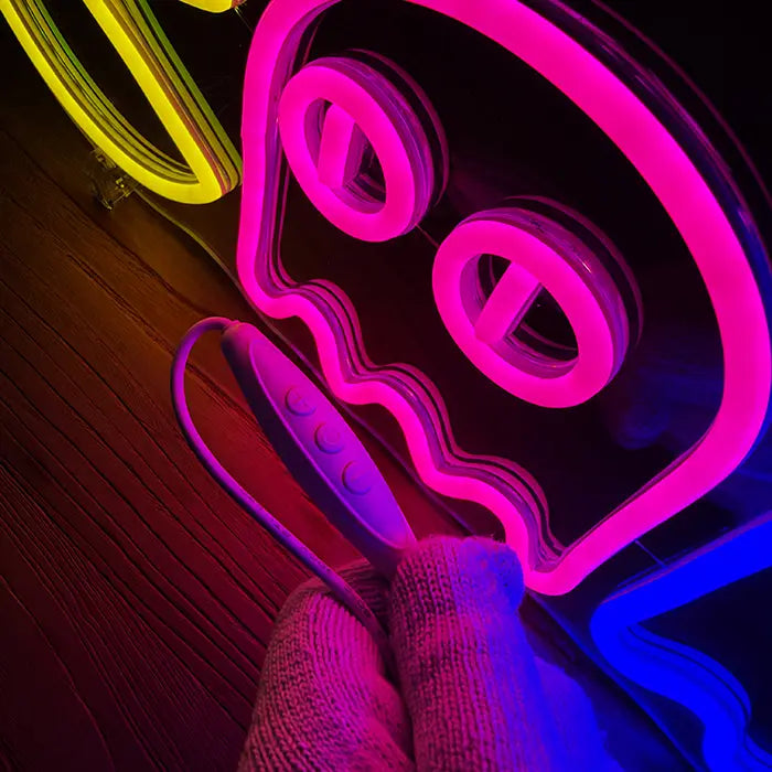 Retro Ghosts Neon LED Sign in close-up, pink ghost with big eyes, inline dimmer in hand