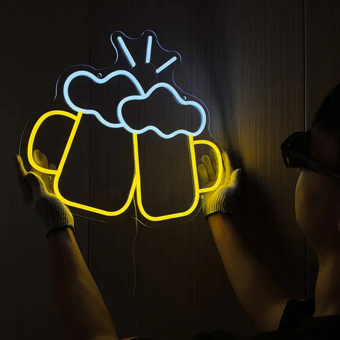 Beer Steins Neon LED Sign on the wall, a person in gloves holds it at the side