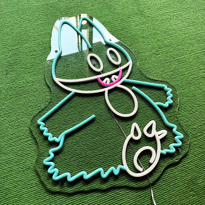 Pokémon Munchlax Neon LED Sign switched off at an angle on a green carpet, outline in turquoise and white