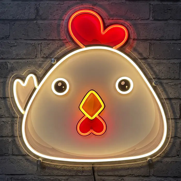 Little Chicken neon LED sign with UV print: round chicken with a cream-printed body, red comb, googly eyes and yellow beak against a brick wall