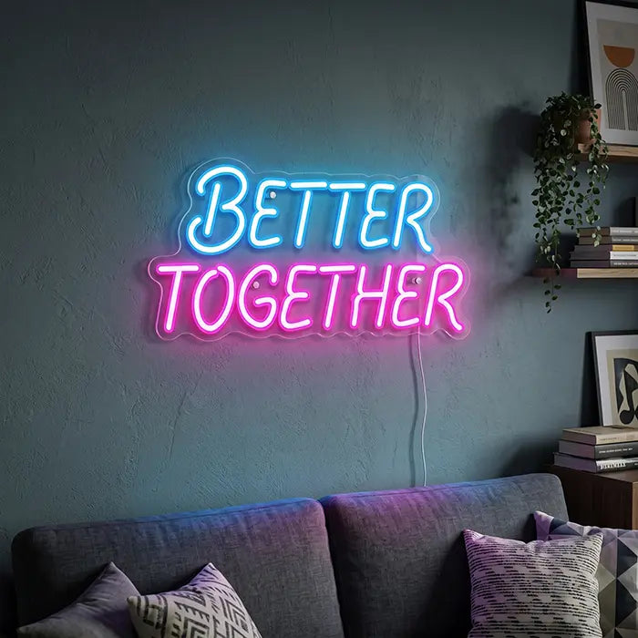 Better Together Neon LED Sign in blue-pink above a grey sofa