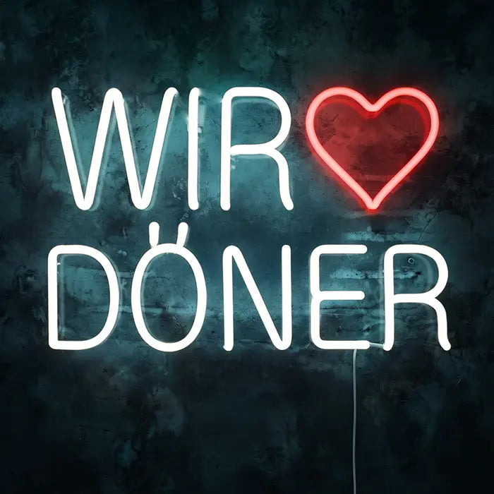 We Love Döner Neon LED Sign front view on a dark wall, white lettering WIR DÖNER with a red heart