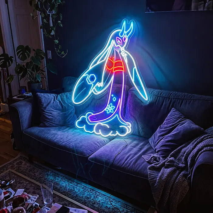 Pokémon Mega Froslass Neon LED Sign above a blue sofa with cushions and a throw