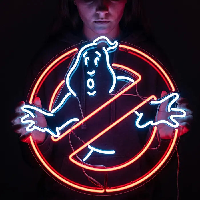 Ghostbusters Logo Neon LED Schild wird vor dem Oberkörper gehalten, roter Kreis und weiße Geisterfigur leuchten
