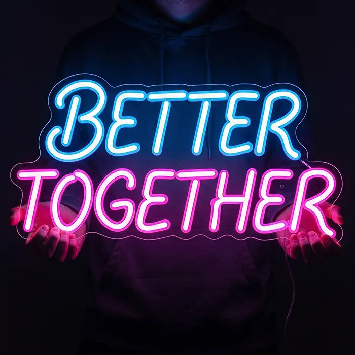 Better Together Neon LED Sign in blue-pink held in front of the body