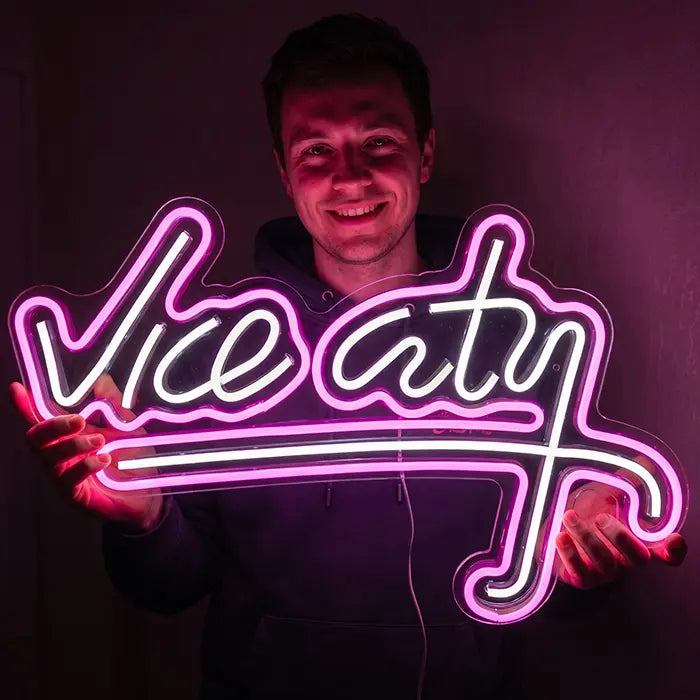 Vice City Original Neon LED Sign held by a smiling man