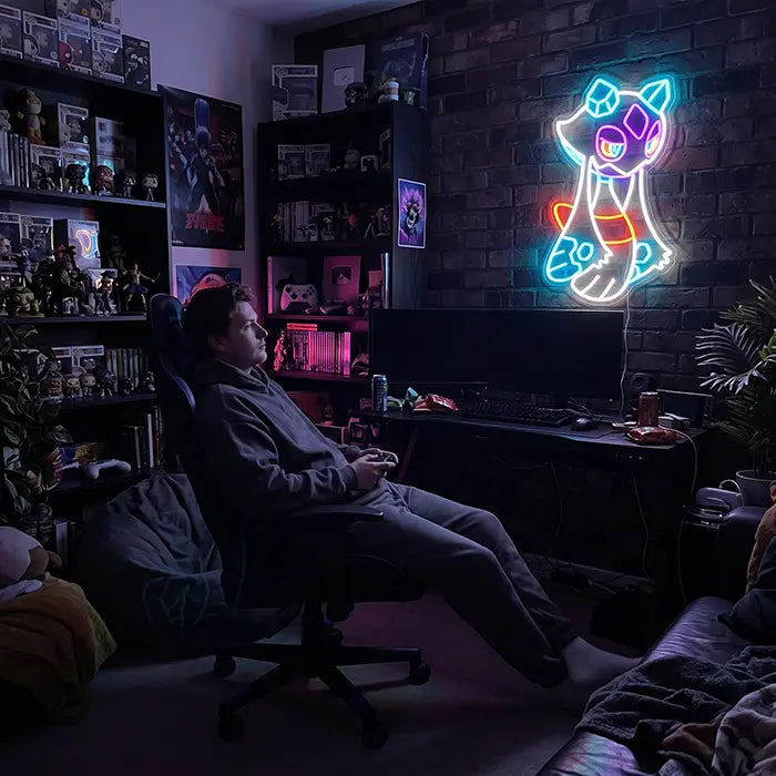 Pokémon Froslass Neon LED Sign above a gaming setup with figure shelves, a man in a gaming chair in front