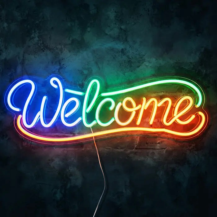 Welcome Neon LED Sign front view on a dark wall, script lettering in a rainbow gradient