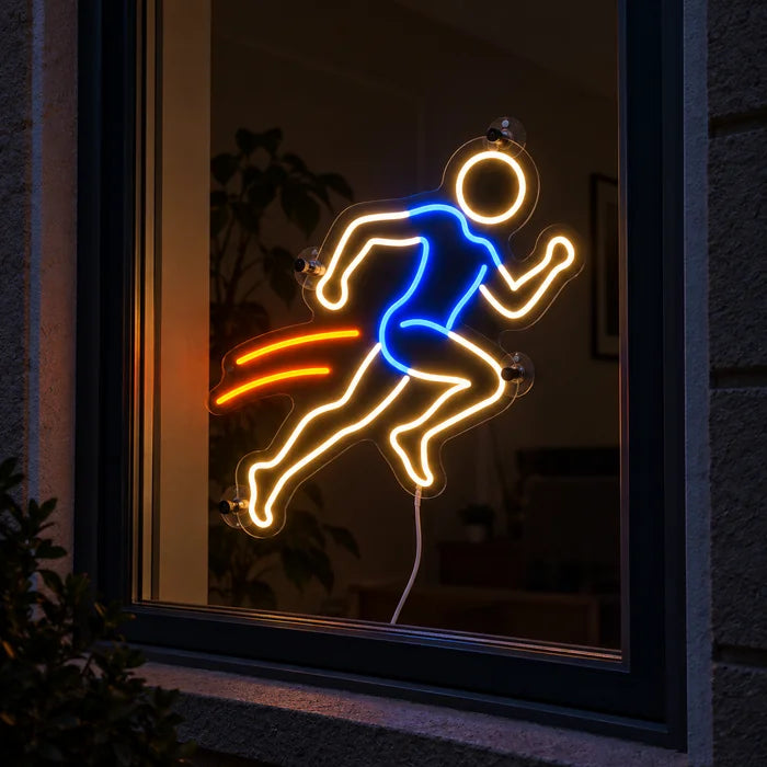 Evening Runner Neon LED Sign in a window, seen from the street at night