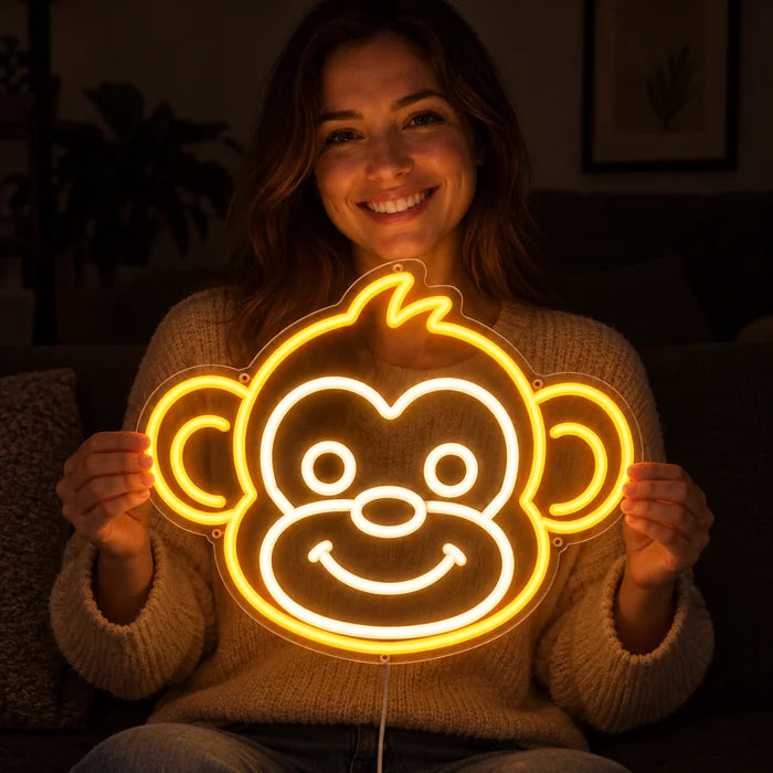 Monkey Face Neon LED Sign held by a smiling woman against a dark background