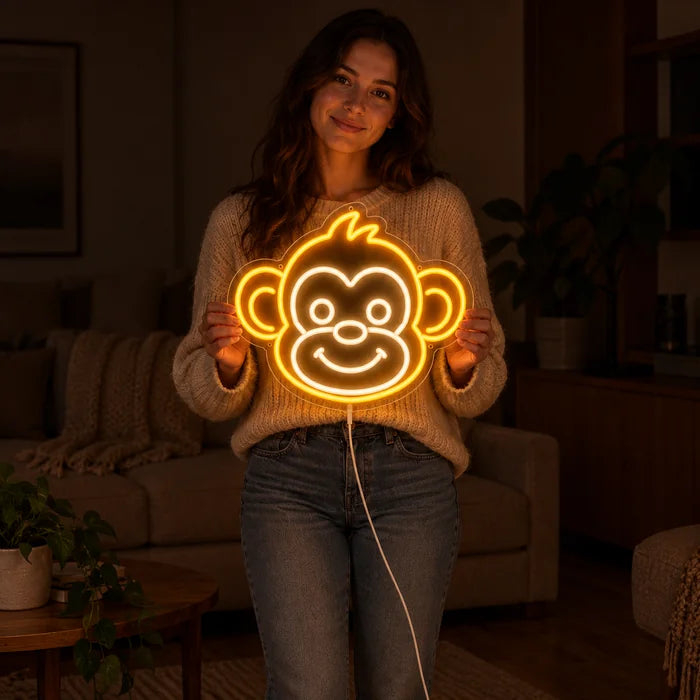 Monkey Face Neon LED Sign held by a woman, showing its size compared to her body
