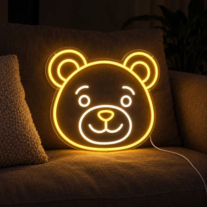 Bear Smile Neon LED Sign on a cosy sofa between cushions and a throw