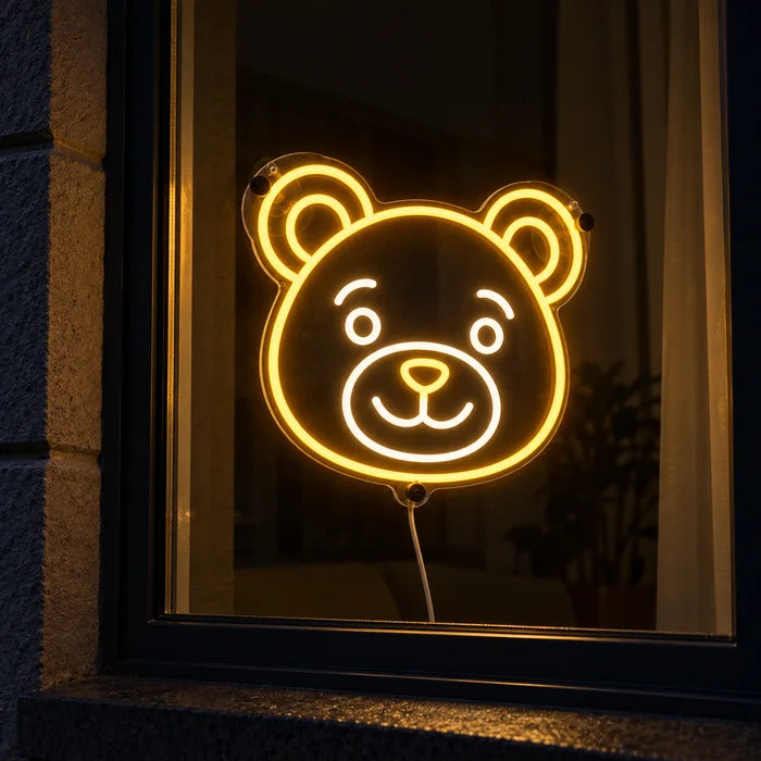 Bear Smile Neon LED Sign in a window, seen from the street at night