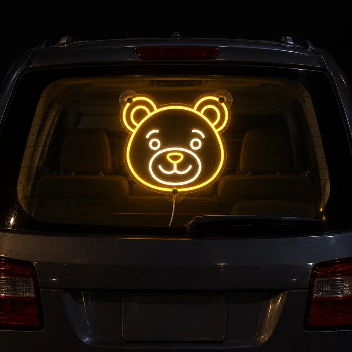 Bear Smile Neon LED Sign on the rear window of a car at night