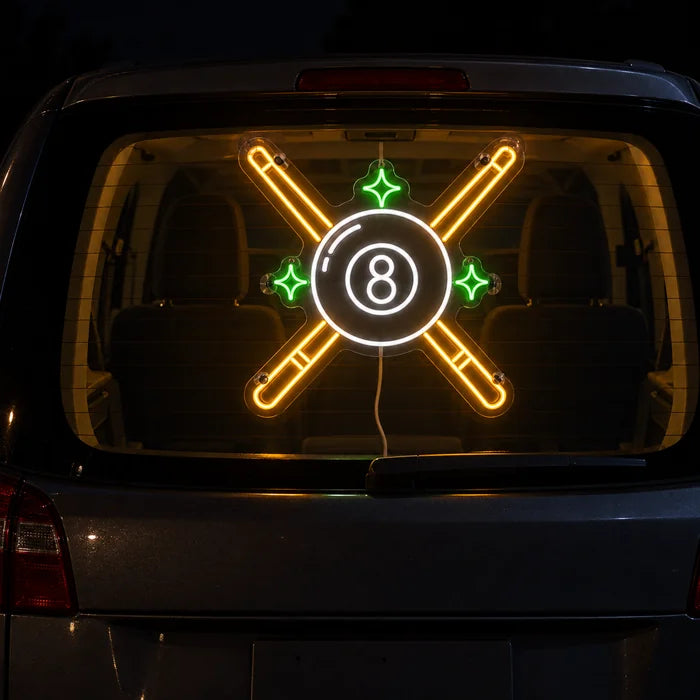 Crossed Pool Cues Neon LED Sign on the rear window of a car at night