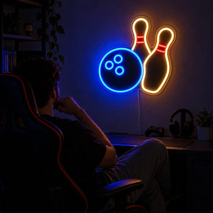 Bowling Night Neon LED Sign above a gaming desk, a gamer in a gaming chair in front of it