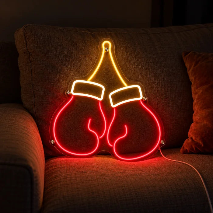 Boxing Gloves Neon LED Sign on a cosy sofa between cushions and a throw