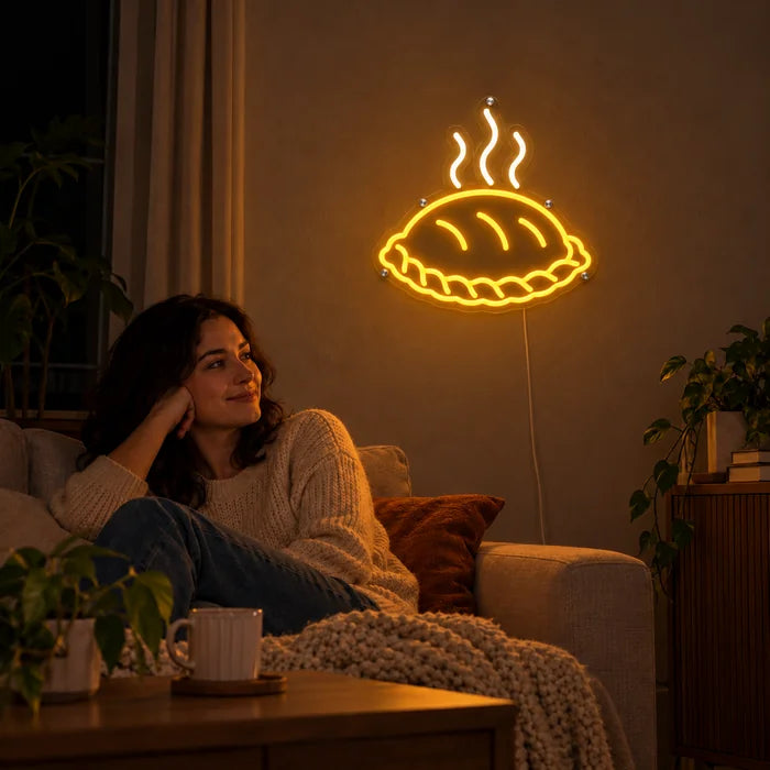 Steaming Dumpling Neon LED Sign on a living room wall, a person relaxing on the sofa in front of it