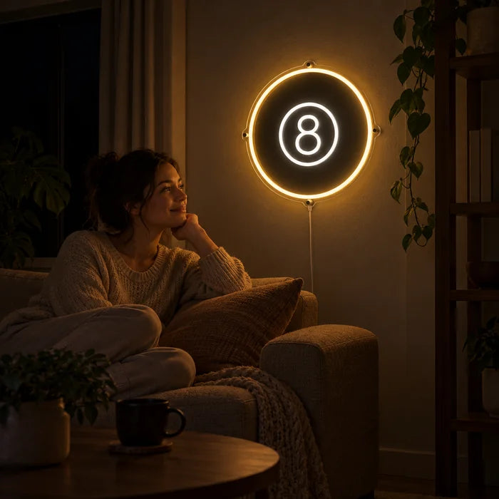 Black Eight Ball Neon LED Sign on a living room wall, a person relaxing on the sofa in front of it